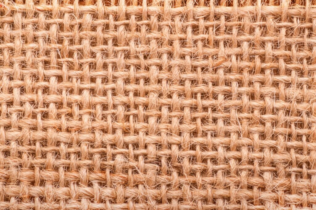 Macro view of woven jute fabric texture, ideal base for sustainable biopolymer coatings in green textiles.